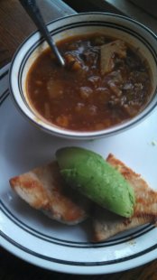 vegetable beef soup and chicken breast with avocado on top